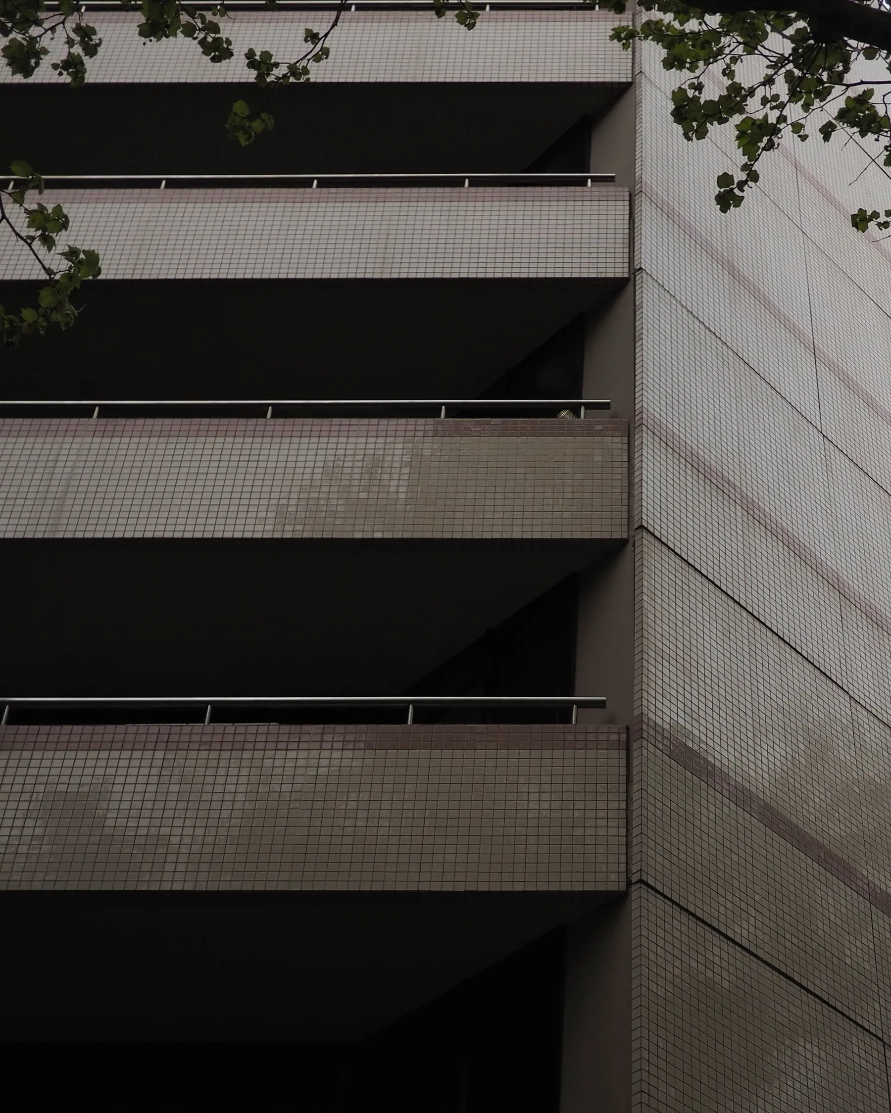 A tiled building with deep shadowed balconies.