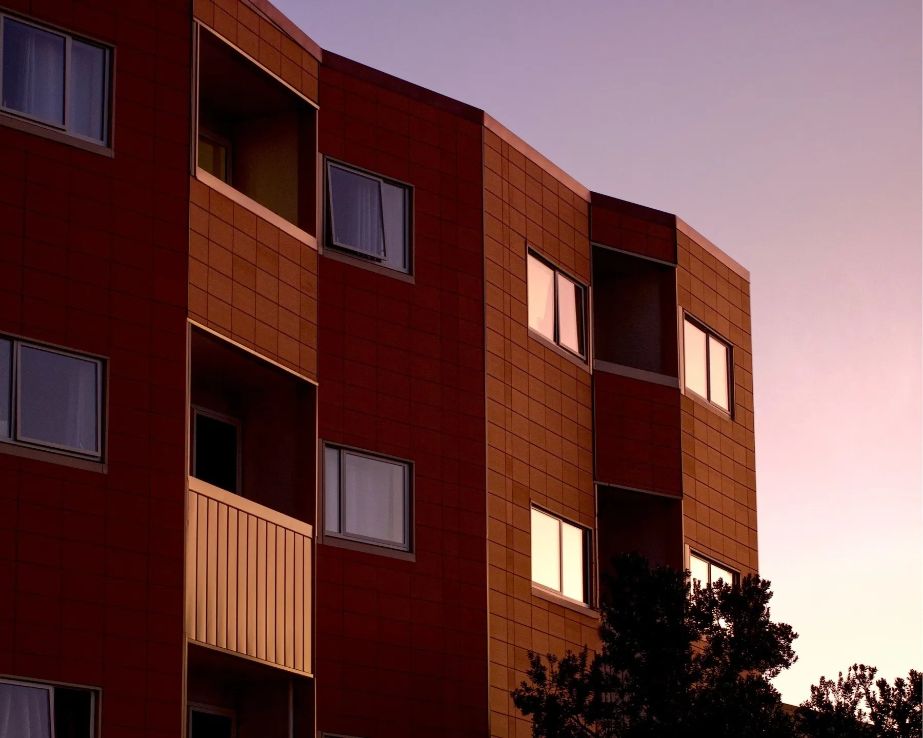 A red zig zag shaped building against the sky