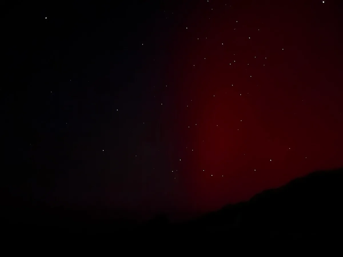 The right half of the night sky with a vertical red beam