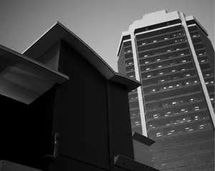A black and white photo of buildings against the sky